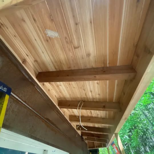 Close-up of new tongue-and-groove wood soffit under the eaves
