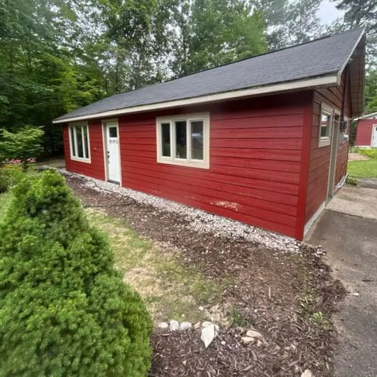 Front entry of a red house with tan trim