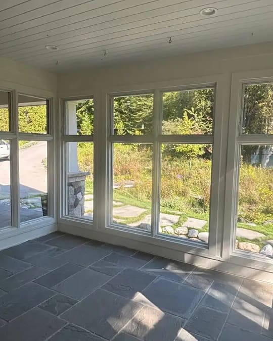 Sun porch with a plank ceiling and windows on three sides